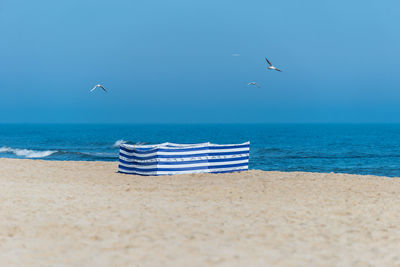 Beach screen on the polish beach on a sunny summer day in the background beautiful sea and gulls.