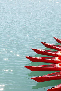 High angle view of red kayaks moored on lake