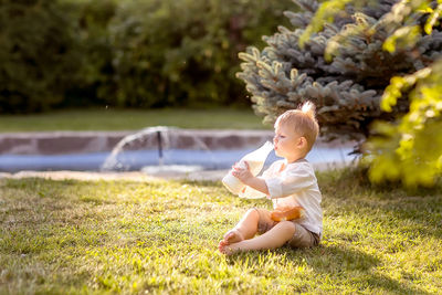 Cute baby girl sitting on grass