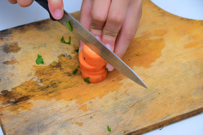 Close-up of person holding ice cream on table