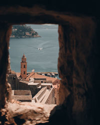 High angle view of sea and buildings against sky