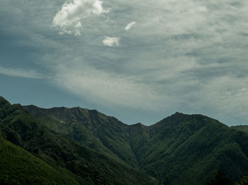 Scenic view of mountains against cloudy sky