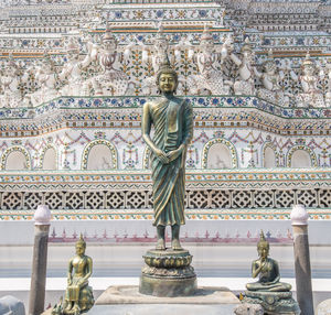 Statue outside temple against building