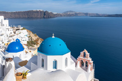 Famous blue domed church in oia, santorini,  greece