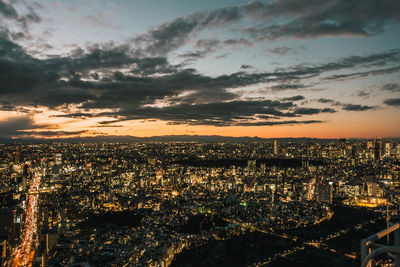 High angle view of illuminated cityscape against sky during sunset