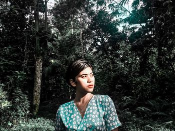 Woman looking away in forest