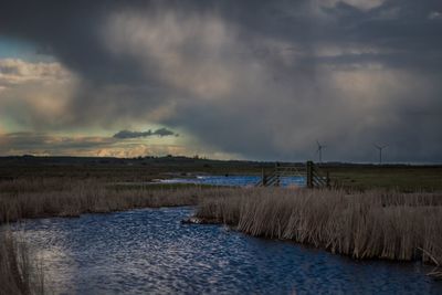 Scenic view of lake against sky during sunset