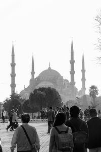 Group of people in front of temple against clear sky