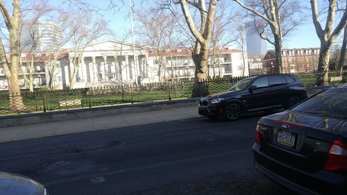 Cars on road by buildings in city