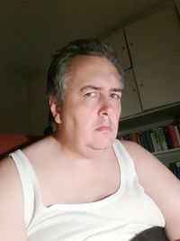 Portrait of young man looking away at home