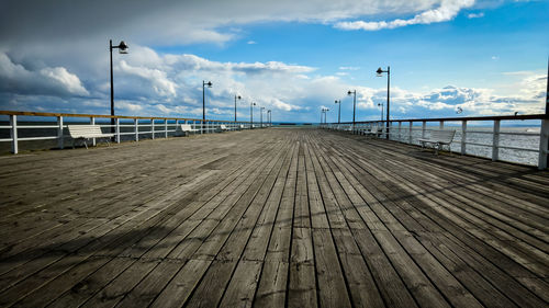 Pier on beach against sky