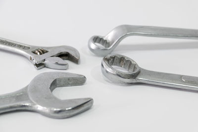 High angle view of tools on table against white background