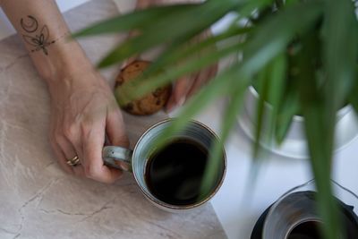 High angle view of person holding drink