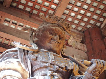 Low angle view of statue against historic building