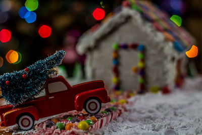Close-up of gingerbread house with christmas decorations at home