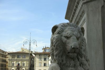 Low angle view of statue in front of building