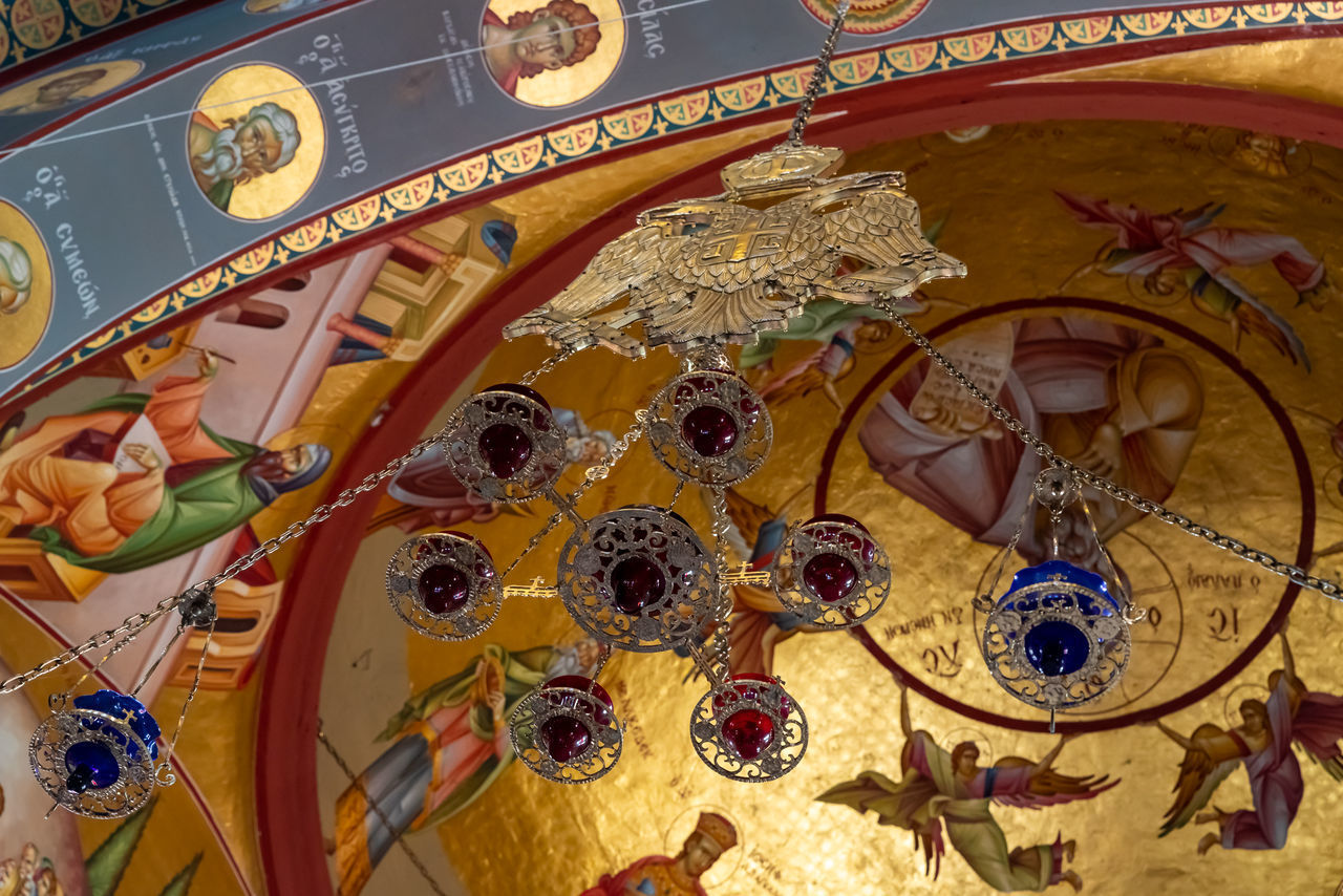 LOW ANGLE VIEW OF MULTI COLORED DECORATIONS ON CEILING OF BUILDING