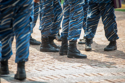 Low section of soldiers standing on footpath