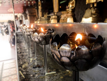 Close-up of burning candles in temple