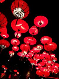 Low angle view of illuminated lanterns hanging at night