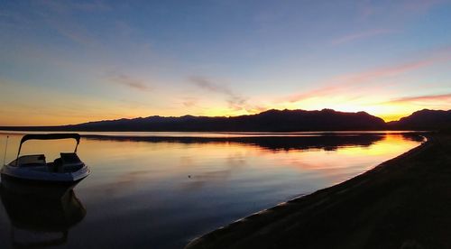 Scenic view of lake against sky during sunset