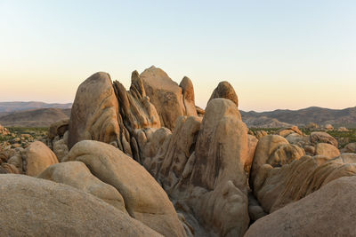 Rock formations against sky during sunset