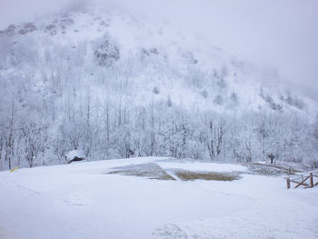 Snow covered landscape against mountain