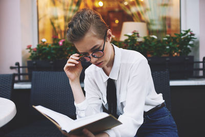 Young woman drinking coffee at cafe