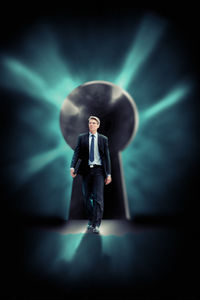 Full length of young man standing against wall