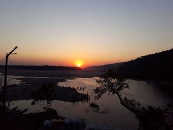 Scenic view of lake against clear sky during sunset