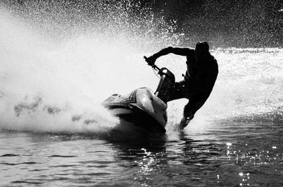 Man riding jet boat in sea