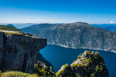 Scenic view of mountains against blue sky