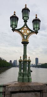 Street light by building against sky