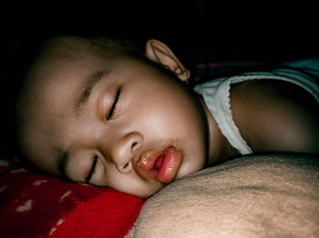 Portrait of cute baby sleeping on bed