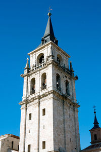 Low angle view of clock tower against blue sky