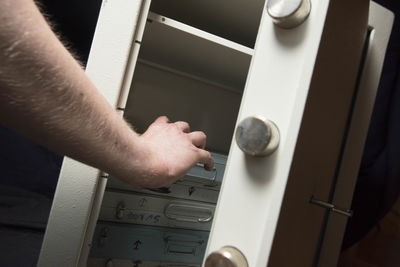 Cropped hand of man holding padlock