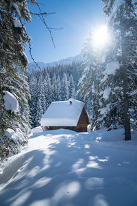 Built structure on snow covered land against sky