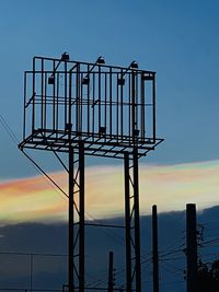 Low angle view of silhouette railing against clear sky