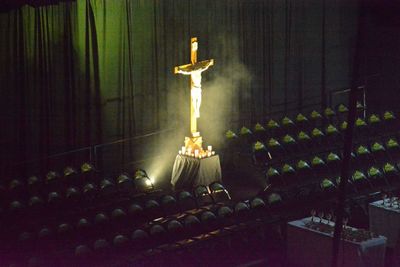 Statue against illuminated lights