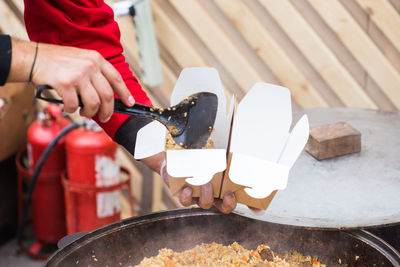 Midsection of man preparing food in kitchen