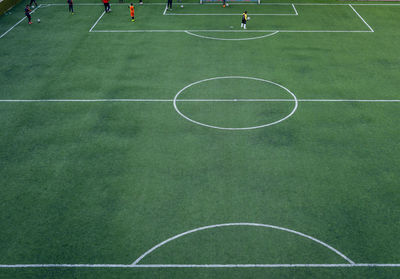 People playing soccer on field