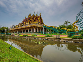 Reflection of temple in lake against sky