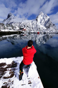 Rear view of man on snowcapped mountain