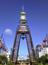 Low angle view of tower against blue sky