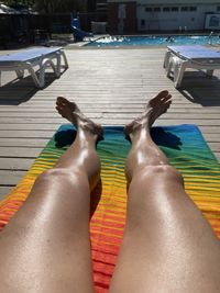Low section of woman relaxing in swimming pool