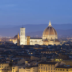 View of illuminated cityscape against sky