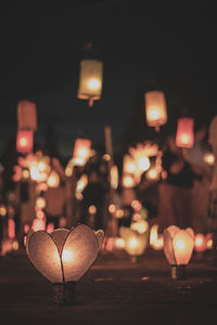 Close-up of illuminated lights on street light at night