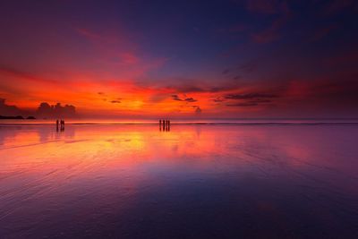 Scenic view of beach against dramatic sky