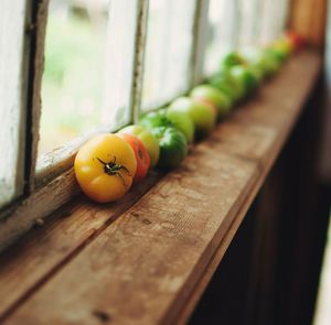 Close-up of yellow tomatoes on wood