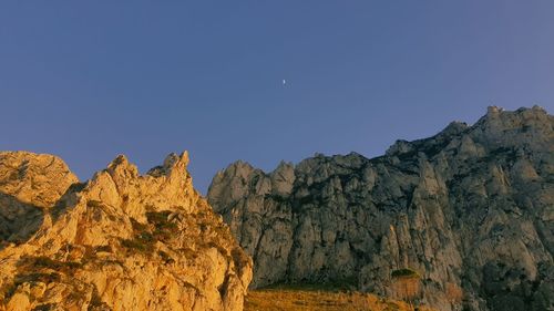 Scenic view of mountains against clear blue sky